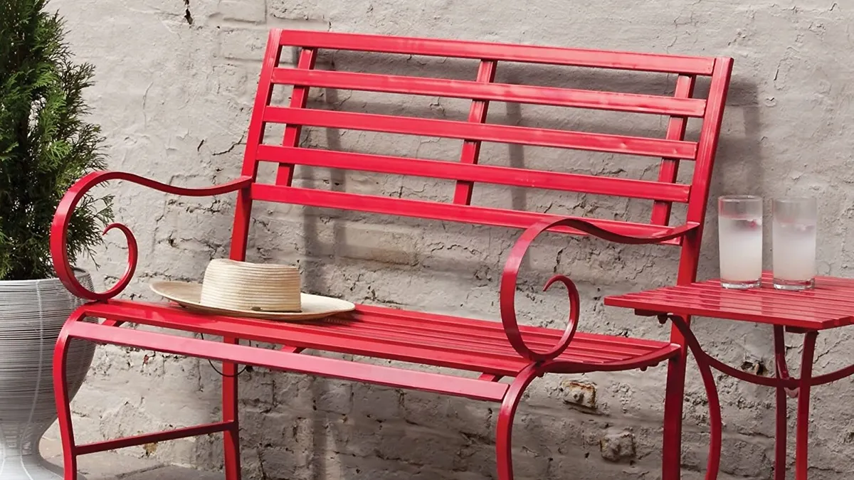 Painted red metal garden bench